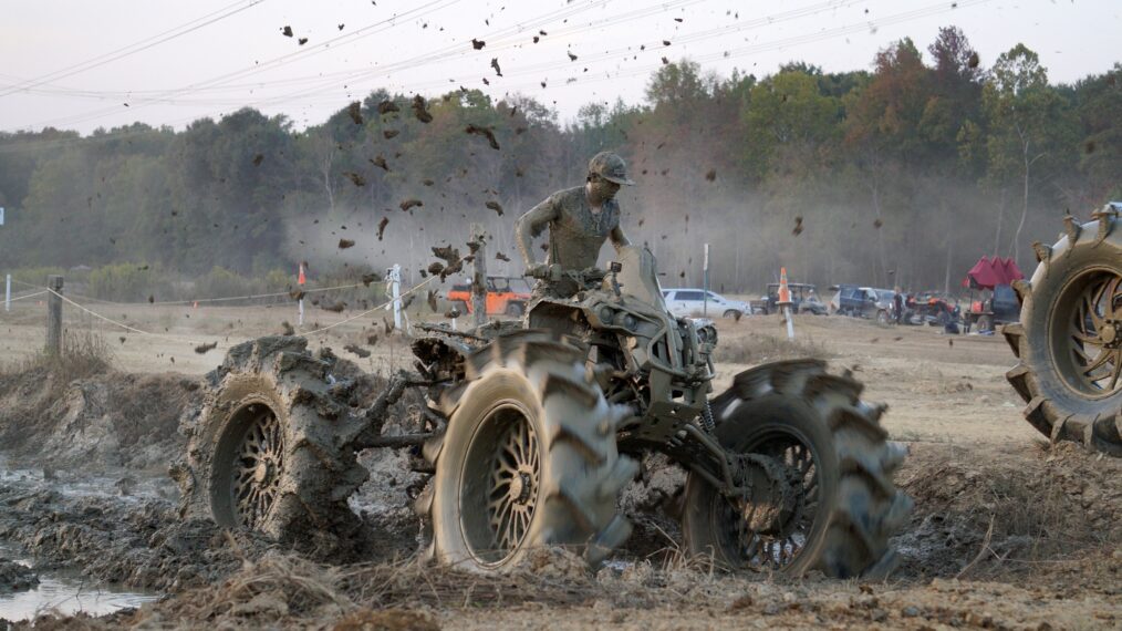 AJ stuck in the middle of the mud on his ATV.