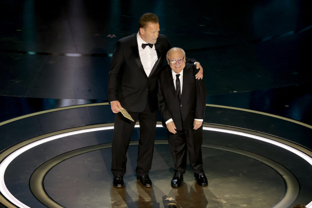 Arnold Schwarzenegger and Danny DeVito speak onstage during the 96th Annual Academy Awards at Dolby Theatre on March 10, 2024 in Hollywood, California.