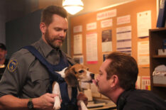 Joel McHale and guest star Thomas Lennon kissing a beagle in the episode of Animal Control