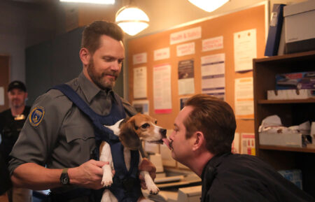 Joel McHale and guest star Thomas Lennon kissing a beagle in the episode of Animal Control