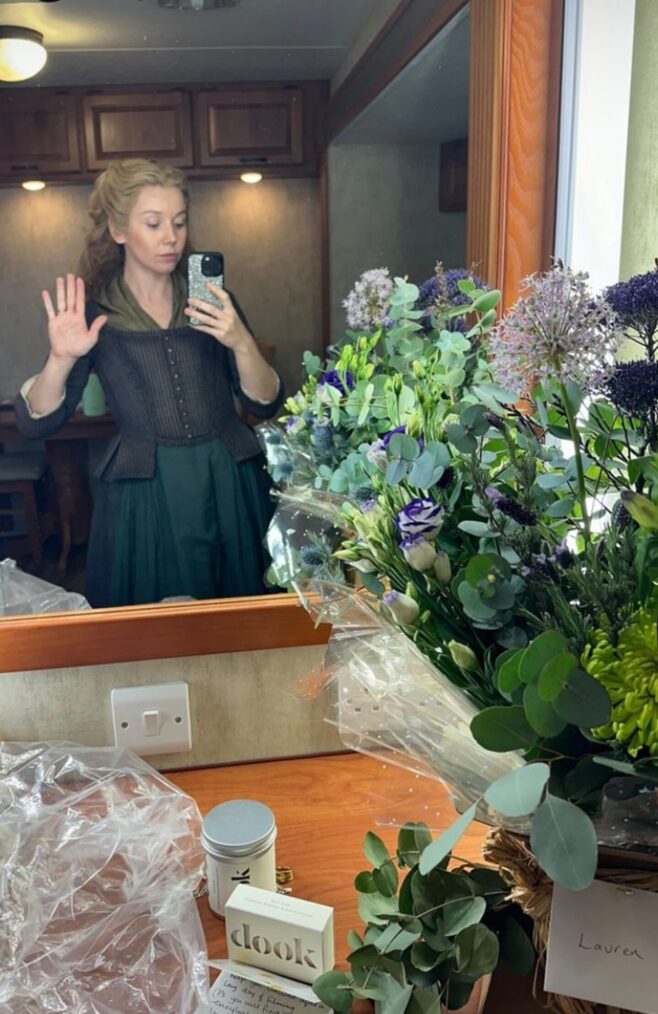 Lauren Lyle poses behind the scenes of 'Outlander' Season 8