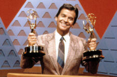 Dick Clark holding Emmys for the $100,000 Pyramid