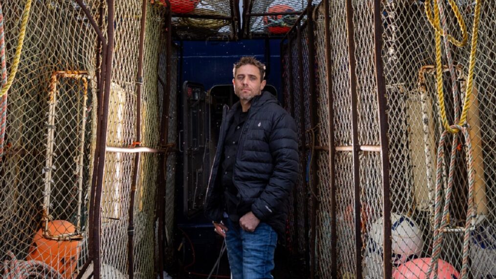 Captian Jake Anderson poses between pots on the deck of the FV Titan Explorer