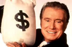 Regis Philbin holding a bag of cash for Who Wants To Be A Millionaire