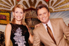 Vanna White and Pat Sajak on Wheel of Fortune showing off one of the prices