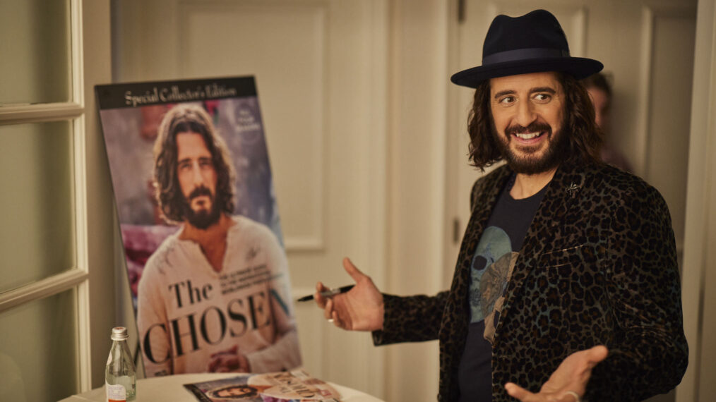 Jonathan Roumie signs the poster of 'The Chosen' Special Collector's Edition Issue of TV Guide Magazine