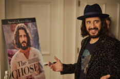 Jonathan Roumie signs the poster of 'The Chosen' Special Collector's Edition Issue of TV Guide Magazine