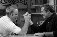 Carroll O'Connor as Archie Bunker arm wrestling Philip Carey as Steve, an ex-professional football player friend of Archie's, in 'All In the Family'