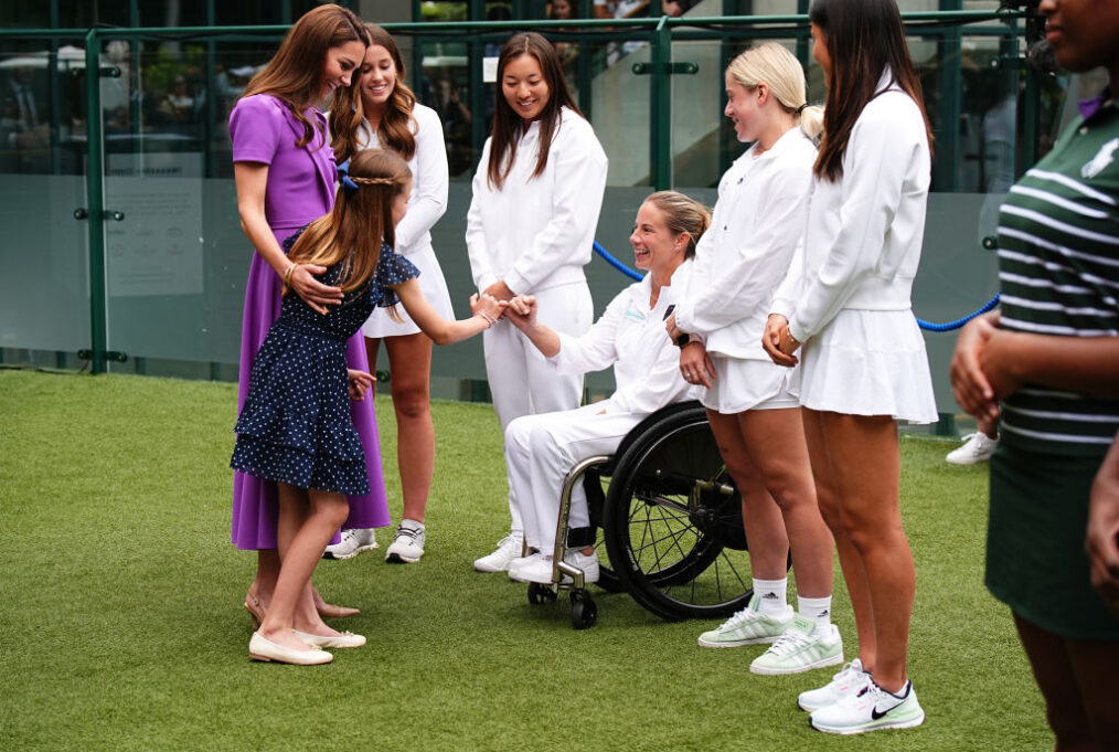 LONDON, ENGLAND - JULY 14: Catherine, Princess of Wales (2nd L) and Princess Charlotte (L) meet Lucy Shuker (C) during a visit to the All England Lawn Tennis and Croquet Club in Wimbledon, south west London, on day fourteen of the Wimbledon Tennis Championships on July 14, 2024 in London, England. The Princess of Wales will present the trophy to the winner of the men's final. (Photo by Aaron Chown - WPA Pool/Getty Images)