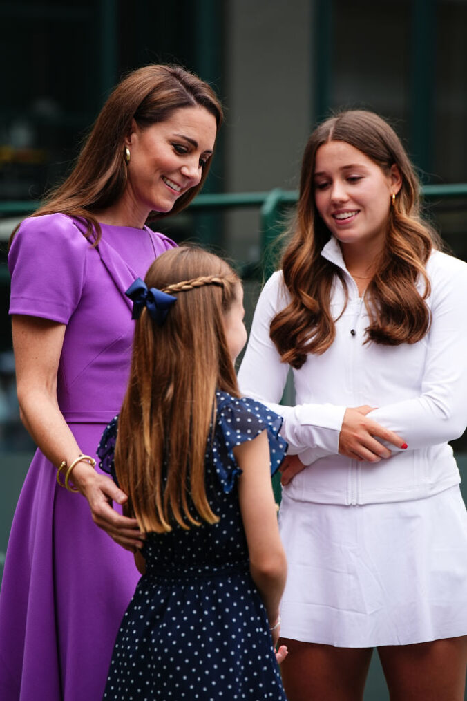 LONDON, ENGLAND - JULY 14: Catherine, Princess of Wales (2nd L) and Princess Charlotte (L) meet Flora Johnson (R) during a visit to the All England Lawn Tennis and Croquet Club in Wimbledon, south west London, on day fourteen of the Wimbledon Tennis Championships on July 14, 2024 in London, England. The Princess of Wales will present the trophy to the winner of the men's final. (Photo by Aaron Chown - WPA Pool/Getty Images)