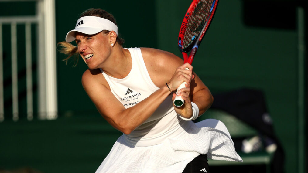 Angelique Kerber of Germany plays a backhand against Yulia Putintseva of Kazakhstan in her Ladies' Singles first round match during day two of The Championships Wimbledon 2024 at