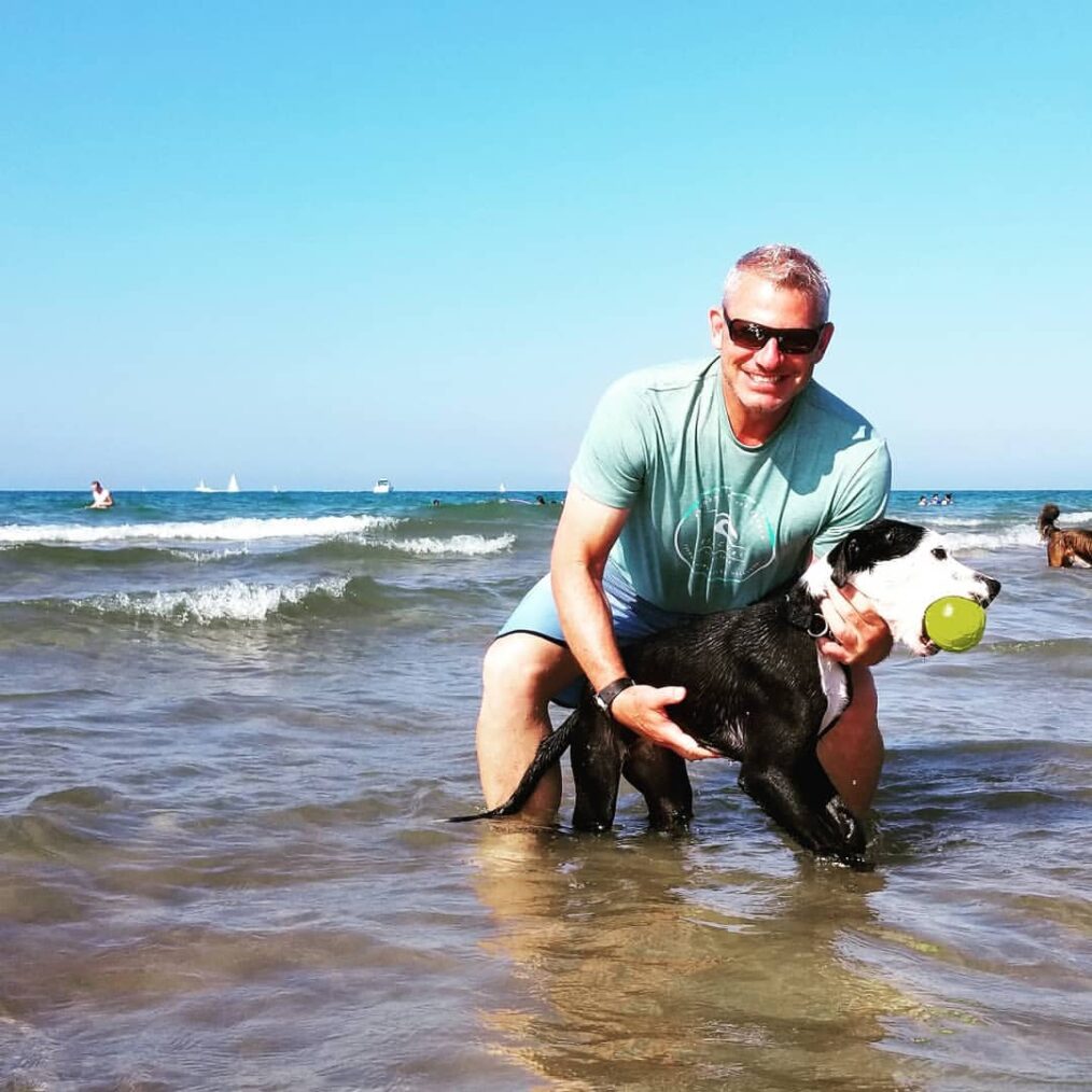 Jordan Heller of 'The Golden Bachelorette' with dog at the beach.