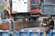 Tony Beets and Kevin Beets sat on side of Kevin's Washplant, happy