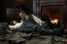 Caitriona Balfe and Sam Heughan by the fire in 'Outlander' Season 6