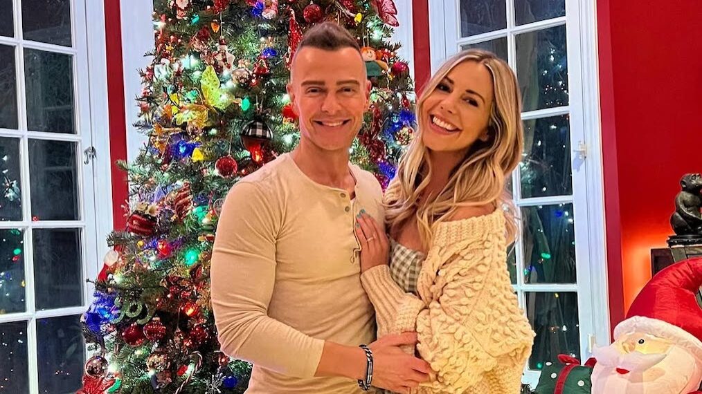 Joey Lawrence and Samantha Cope in front of a christmas tree.