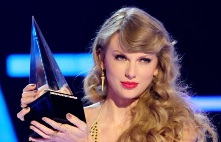 Taylor Swift accepting a trophy at the 2022 American Music Awards