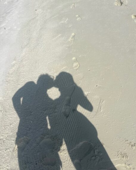 Meghann Fahy and Leo Woodall Kissing on the Beach