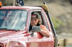 Rick Ness leaning out truck window, red truck.