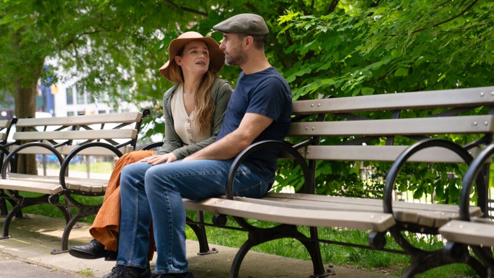 Marc and Amber de la Motte talking on park bench at Morningside Park