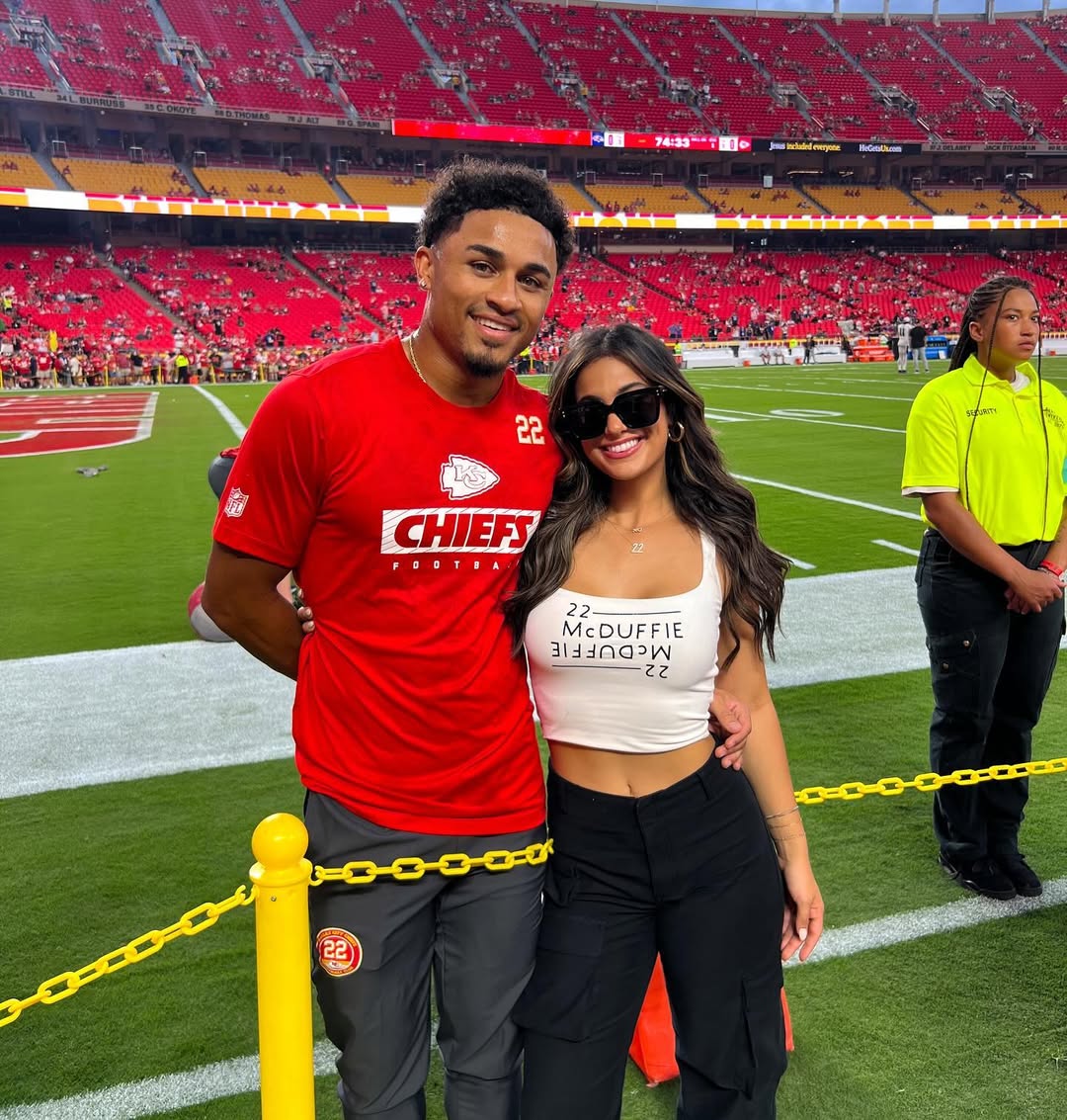Trent McDuffie and Gabby Esposito at a football game