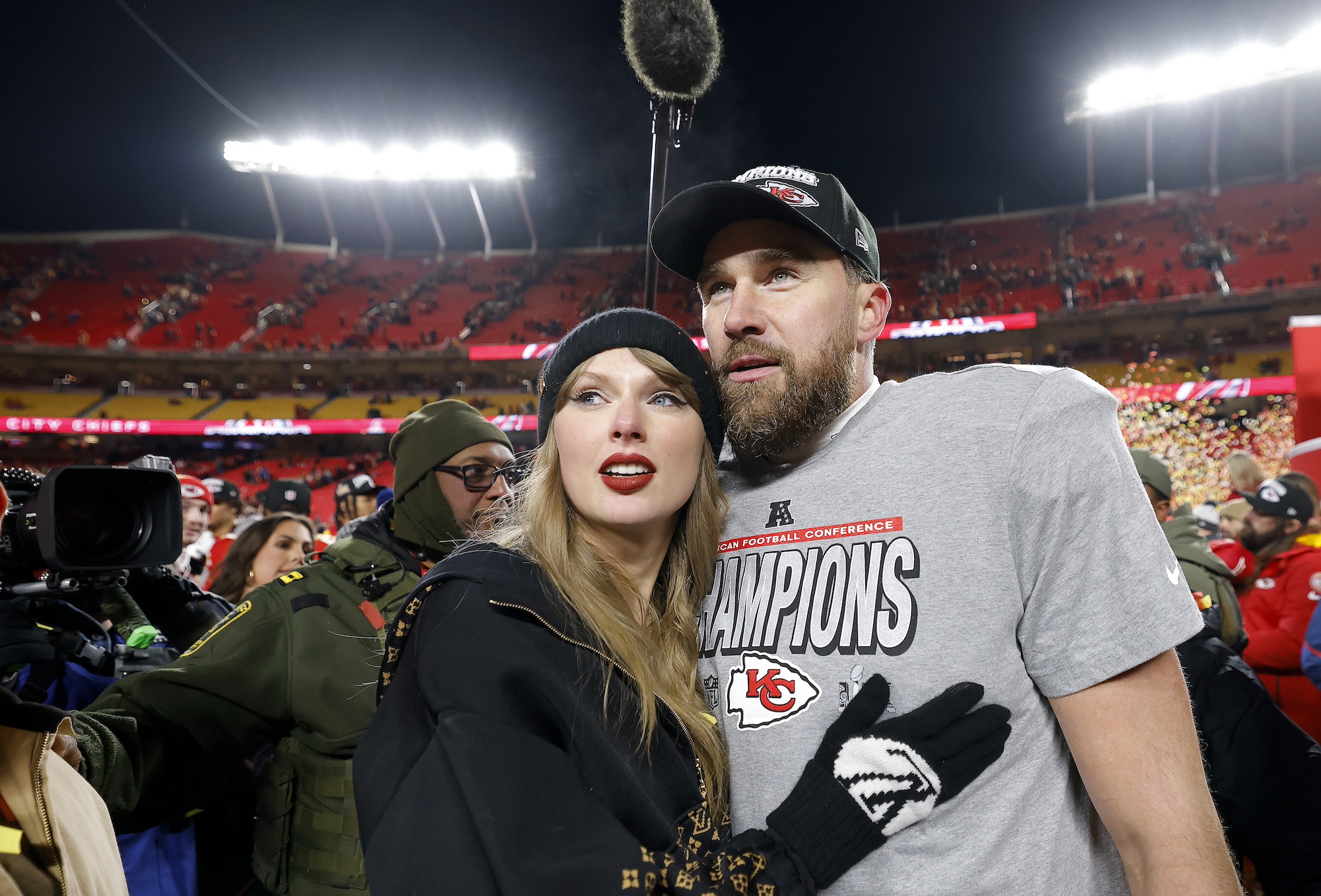 Taylor Swift celebrates with Travis Kelce #87 of the Kansas City Chiefs after defeating the Buffalo Bills 32-29 in the AFC Championship Game
