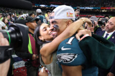 Jalen Hurts #1 of the Philadelphia Eagles and fiancee, Bry Burrows, embrace after defeating the Kansas City Chiefs 40-22 to win Super Bowl LIX