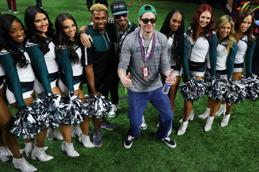 Actor Pete Davidson poses for photos with members of the Philadelphia Eagles cheerleading squad before Super Bowl LIX