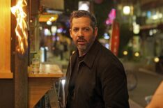 David Blaine prepares to spit fire onto a wooden sign