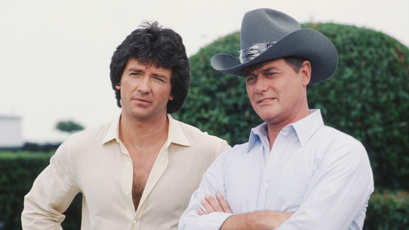 American actors Patrick Duffy and Larry Hagman, as Bobby Ewing and John Ross 'J.R.' Ewing Jr., stand together in a promotional still from the American television series 'Dallas,' August 1982.