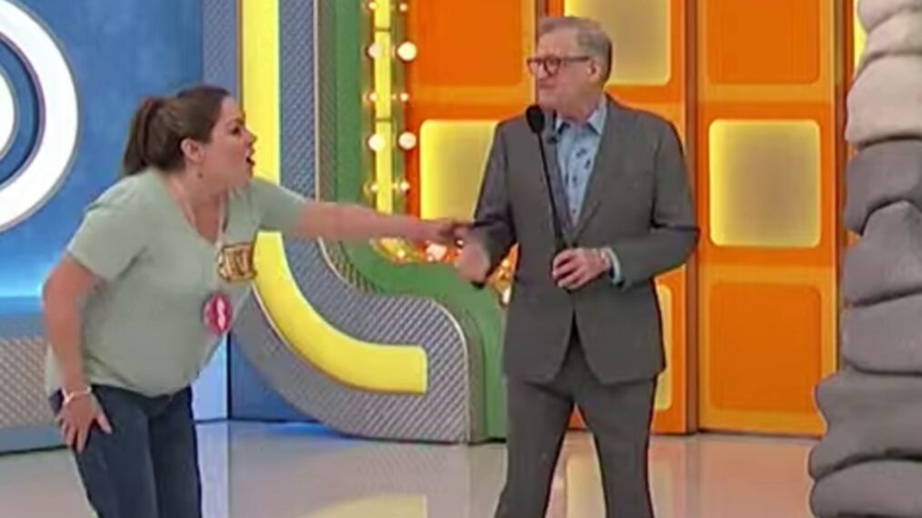 The Price is Right contestant Christina clutching Drew Carey's arm on May 2, 2025