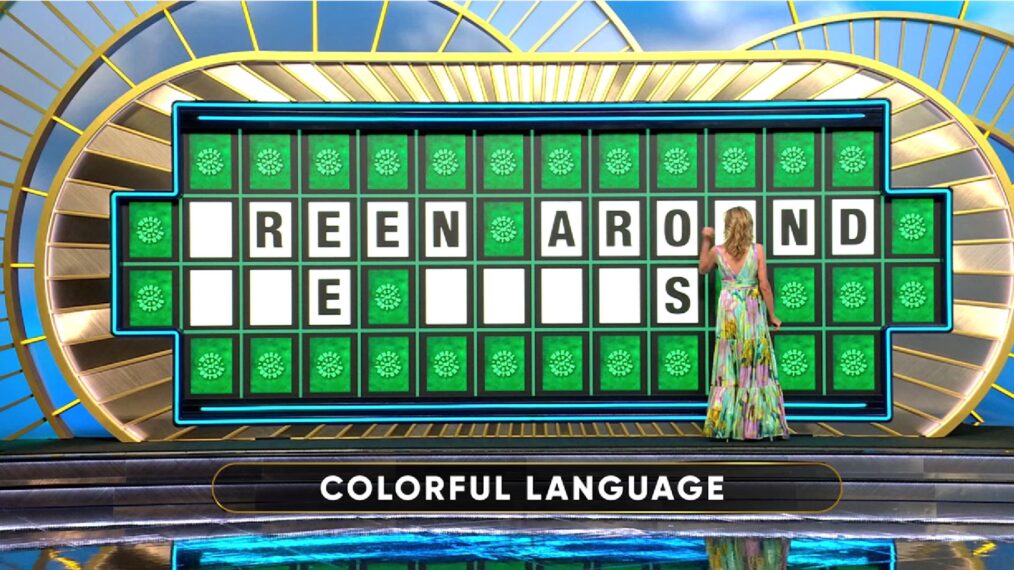 Vanna White touching letters on the Wheel of Fortune board