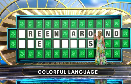 Vanna White touching letters on the Wheel of Fortune board