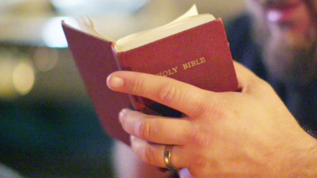 Close up of Tripp Fuller holding a Bible - 'The Road to Edmond'