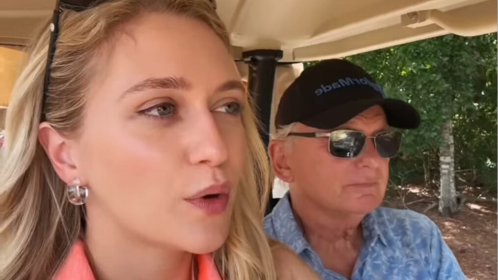 Maggie and Pat Sajak riding in a golf cart