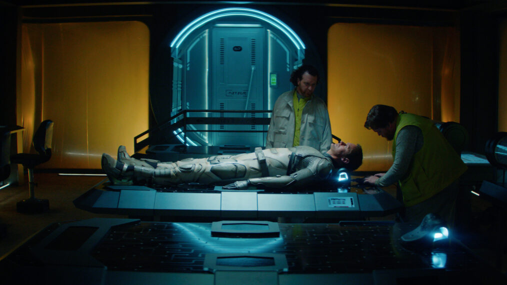 Murderbot Finale Alex Skarsgard on table