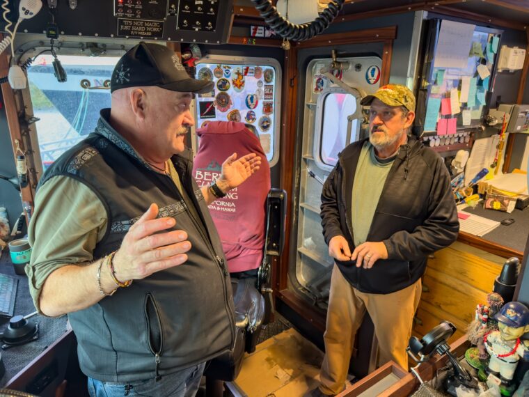 Wizard captains Keith and Monte have a discussion in the wheelhouse.