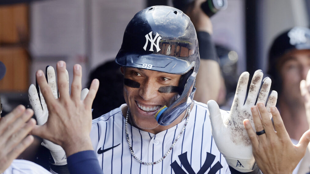 Aaron Judge #99 of the New York Yankees celebrates in the dugout after his ninth inning two run home run against the Chicago Cubs at Yankee Stadium on July 12, 2025 in New York City.