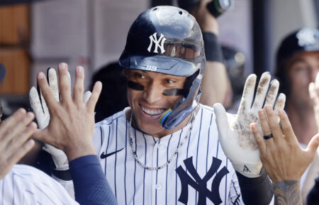 Aaron Judge #99 of the New York Yankees celebrates in the dugout after his ninth inning two run home run against the Chicago Cubs at Yankee Stadium on July 12, 2025 in New York City.