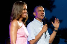 U.S. President Barack Obama (R), accompanied by first lady Michelle Obama, gives remarks to members of the military and White House staff