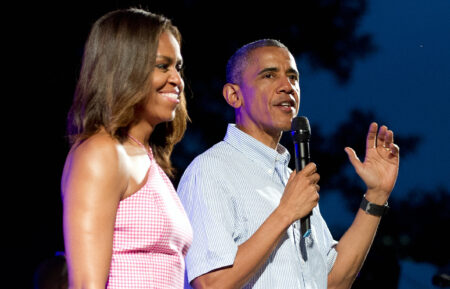 U.S. President Barack Obama (R), accompanied by first lady Michelle Obama, gives remarks to members of the military and White House staff