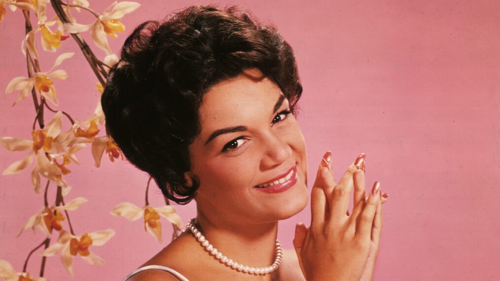Studio portrait of American singer Connie Francis wearing a lavender and white spaghetti-strap dress.