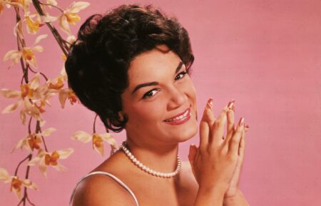 Studio portrait of American singer Connie Francis wearing a lavender and white spaghetti-strap dress.