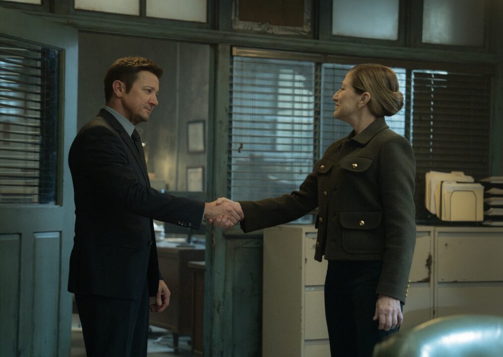 L-R: Jeremy Renner as Mike McLusky and Edie Falco as Nina Hobbs in Mayor of Kingstown season 4, streaming on Paramount+, 2025. Credit: Dennis P. Mong Jr./Paramount+ ©2025 Viacom International Inc. All Rights Reserved. Mayor of Kingstown and all related titles, logos and characters are trademarks of Viacom International Inc.