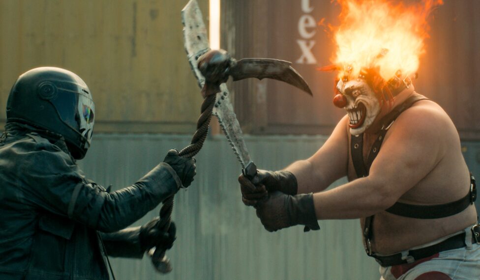 TWISTED METAL -- “OHLYNTE” Episode 211 -- Pictured: (l-r) Richard De Clerk as Mr. Grimm, Joe Seanoa as Sweet Tooth— (Photo by: PEACOCK)