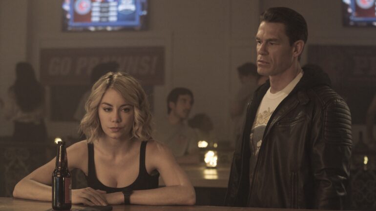 Jennifer Holland and John Cena in Peacemaker Season 1