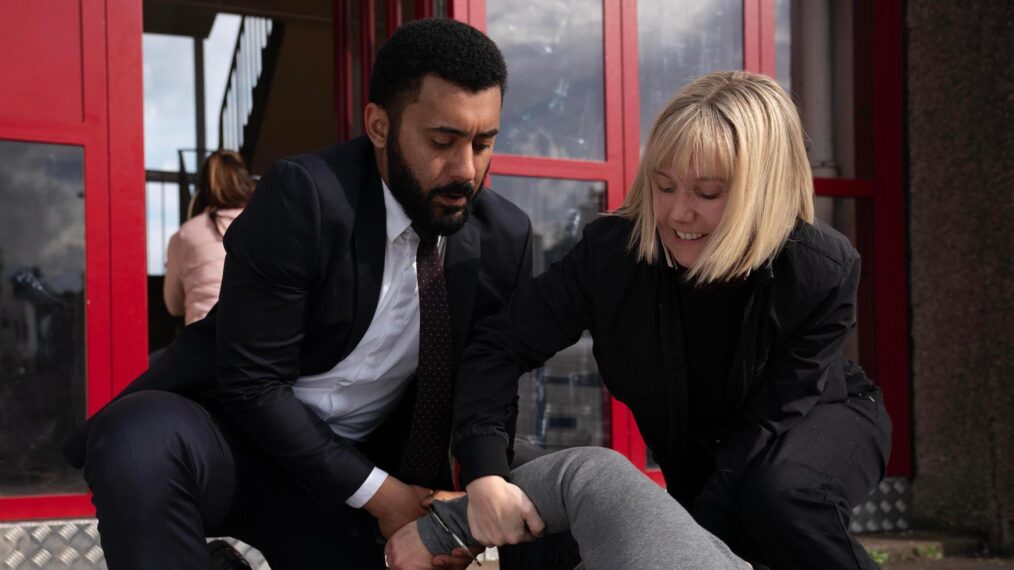 Zach Wyatt as Phil Parhatka and Lauren Lyle as Karen Pirie in 'Karen Pirie' Season 2 on BritBox