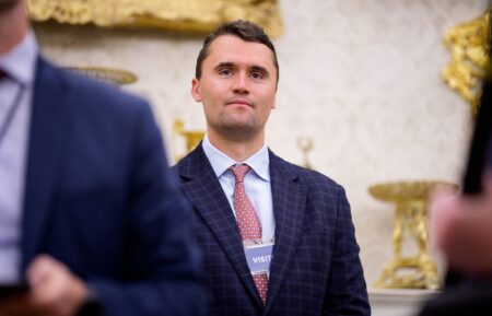 WASHINGTON, DC - MAY 28: Turning Point USA co-founder Charlie Kirk stands in the back of the room as U.S. President Donald Trump speaks during a swearing in ceremony for interim U.S. Attorney for Washington, D.C. Jeanine Pirro in the Oval Office of the White House on May 28, 2025 in Washington, DC. Trump has announced Pirro, a former Fox News personality, judge, prosecutor, and politician, after losing support in the Senate for his first choice, Ed Martin, over his views on the January 6, 2021 attack on the U.S. Capitol. (Photo by Andrew Harnik/Getty Images)
