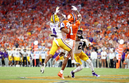CLEMSON, SOUTH CAROLINA - AUGUST 30: T.J. Moore #1 of the Clemson Tigers attempts to get the ball against Mansoor Delane #4 and Jardin Gilbert #2 of the LSU Tigers during the first quarter at Memorial Stadium on August 30, 2025 in Clemson, South Carolina. (Photo by Katie Januck/Getty Images)