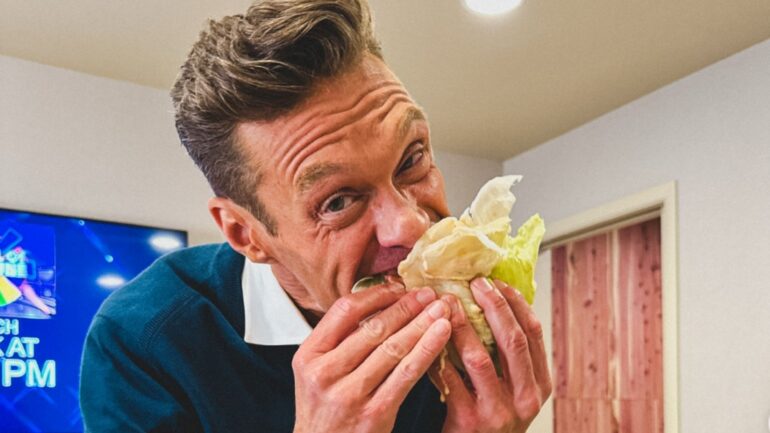 Ryan Seacrest eating In-N-Out burger in hid dressing room on September 11, 2025 on the set of 