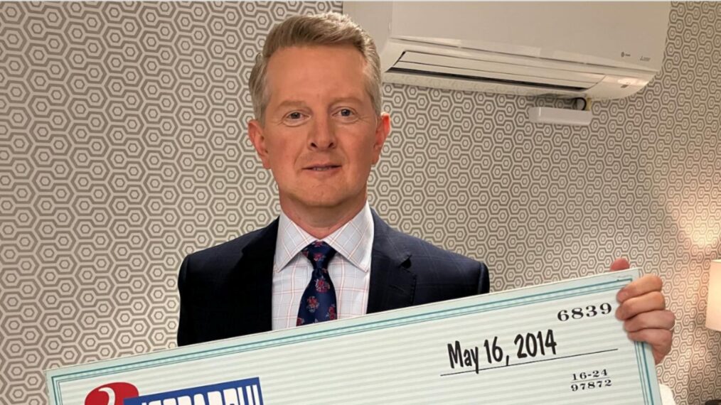 'Jeopardy!' host Ken Jennings holding a check from his time on the game show